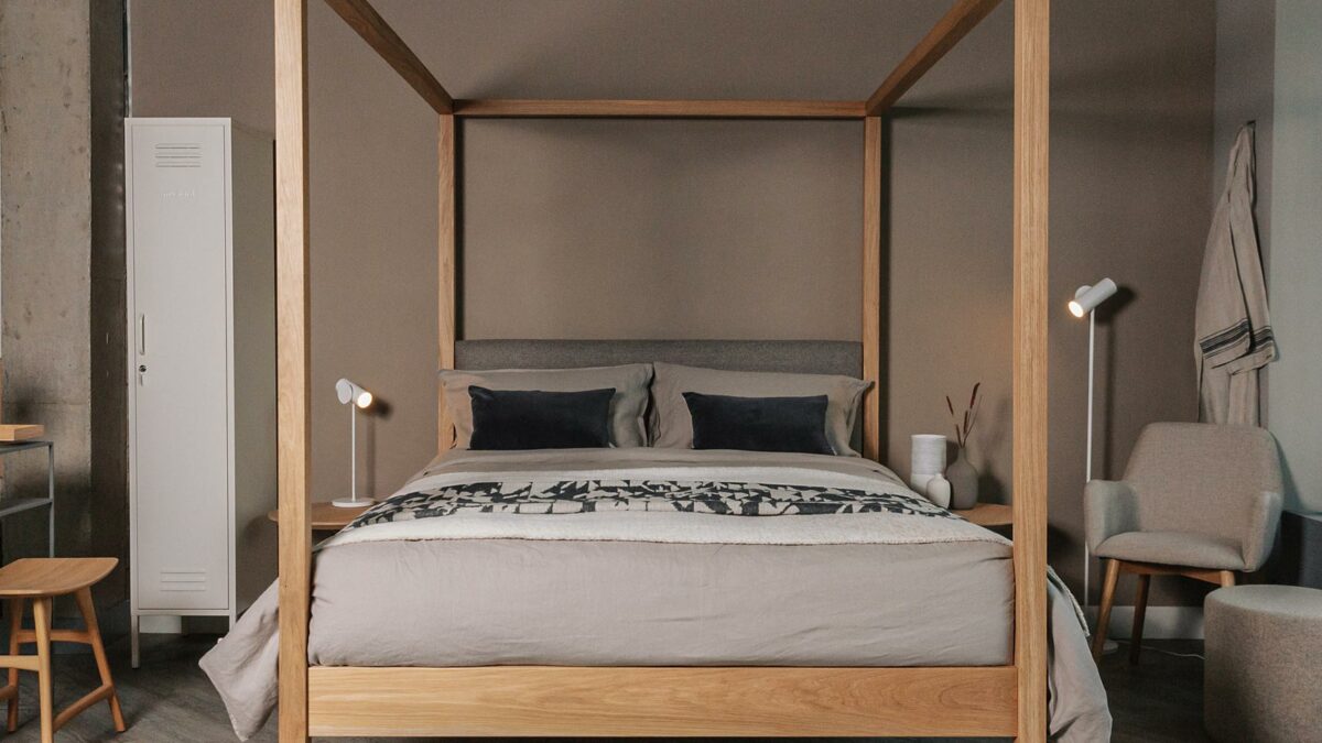 contemporary classic Highland 4 Poster bed in solid oak shown with in a neutral colour bedroom scheme