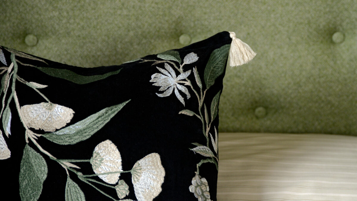 detail view of the floral embroidered black velvet cushion