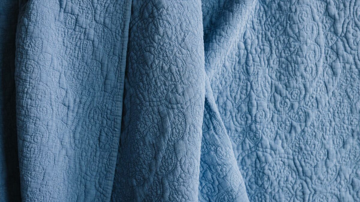 cornflower blue embroidered bedspread detail