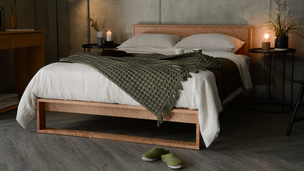 cosy industrial bedroom style with cherry wood Leith bed and hints of green