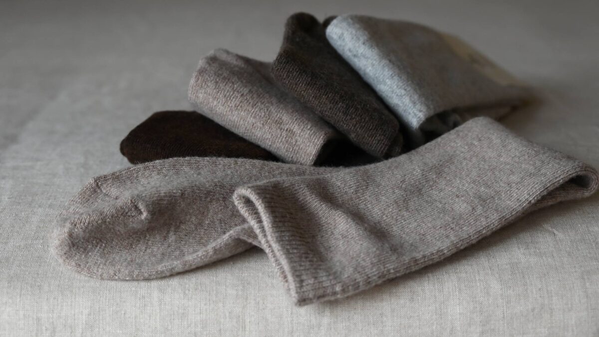 Dark brown, oatmeal, mid brown and grey socks folded.