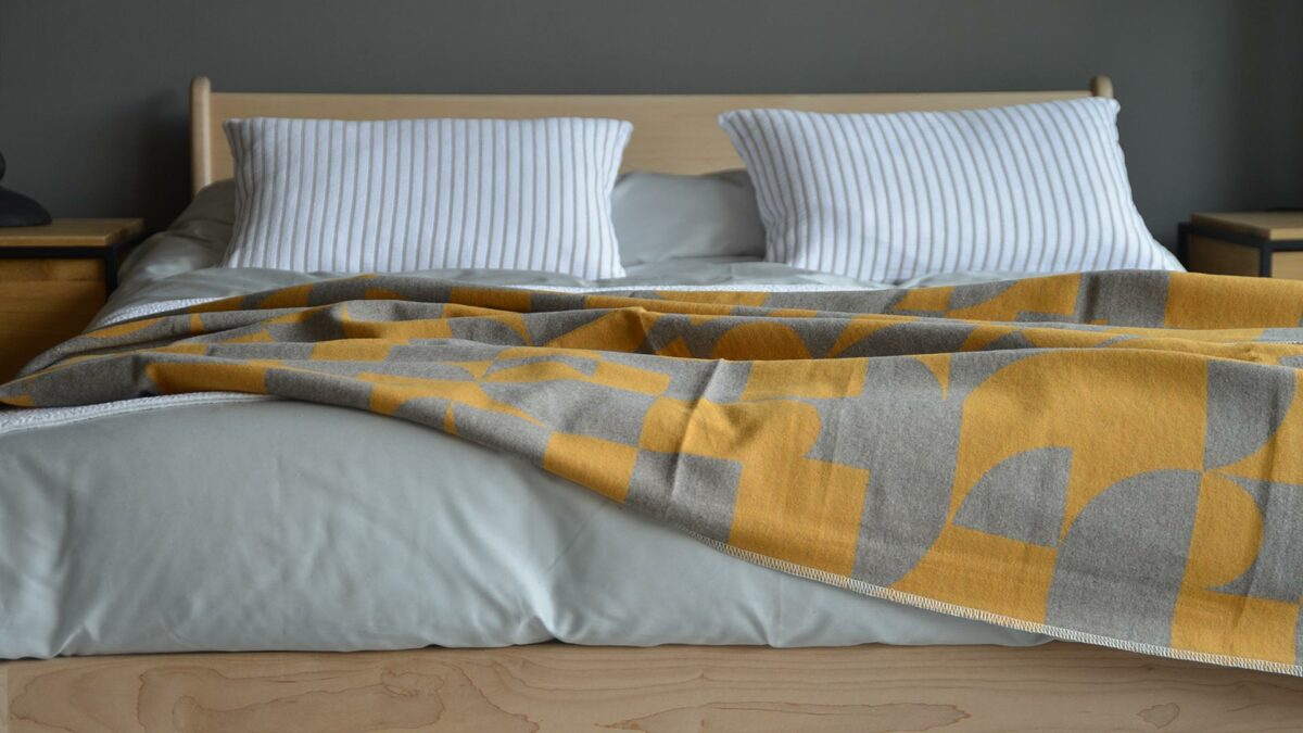 cosy modern blanket with graphic print in grey and mustard