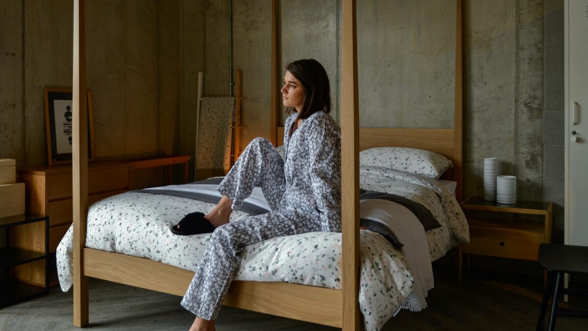 cosy pyjamas black sheepskin slippers and terrazzo print bedding
