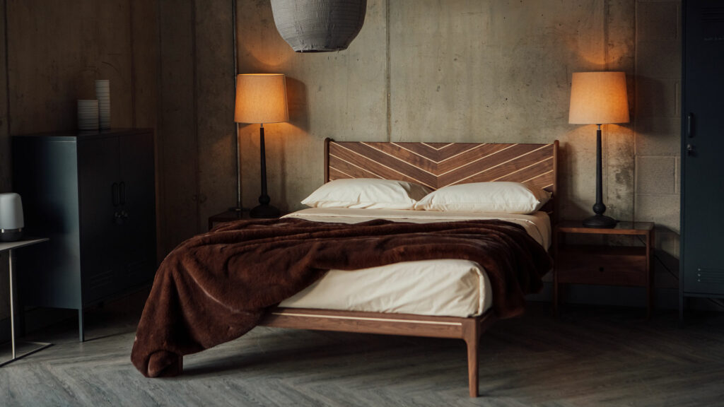 Classic bedroom style featuring a handcrafted solid wood bed in walnut and maple with Chevron design to the headboard