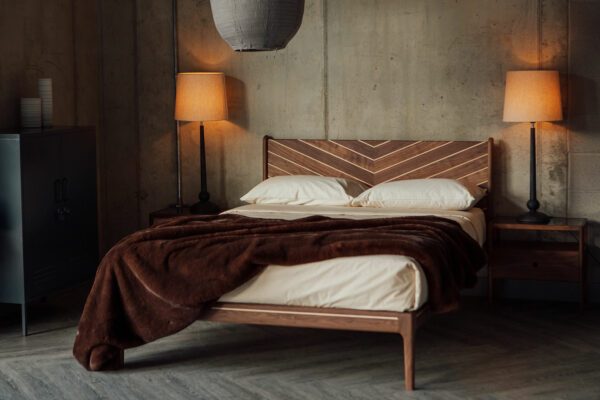 Classic bedroom style featuring a handcrafted solid wood bed in walnut and maple with Chevron design to the headboard