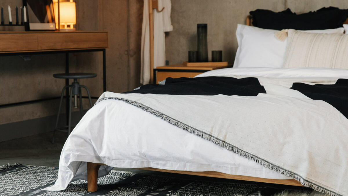 Cosy monochrome bedroom look with ethnic style black and white printed cotton rug