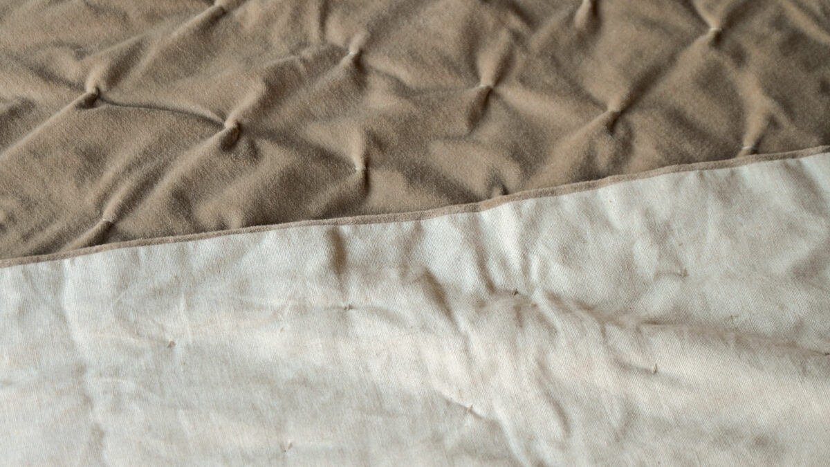 pale brown softly quilted reversible velvet bedspread a picture showing the front and linen look reverse