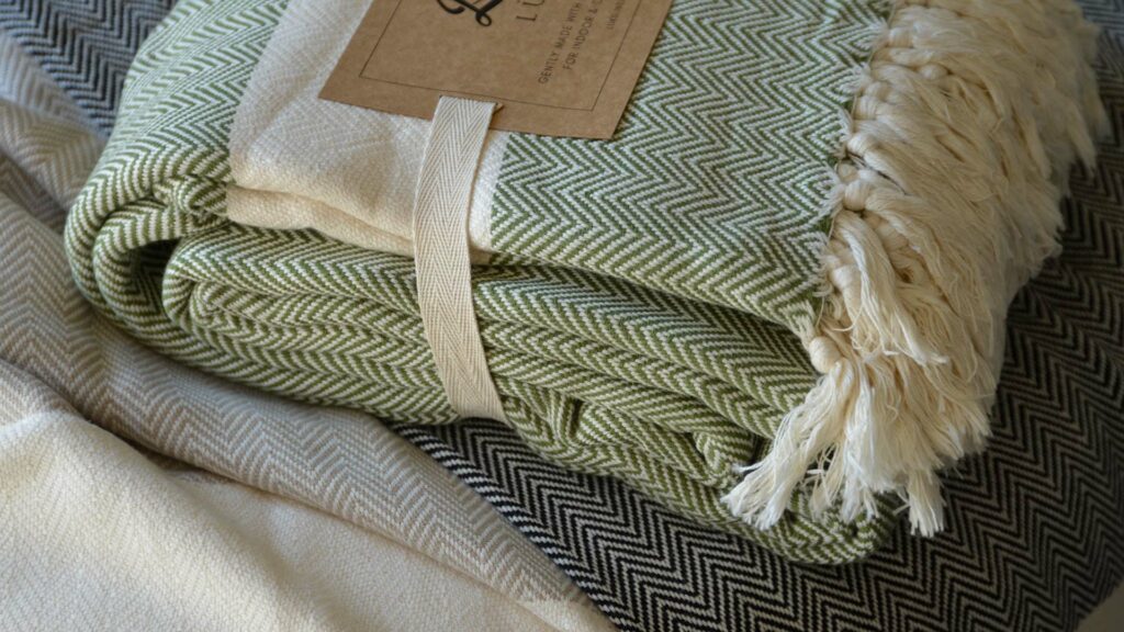 Ethically made woven cotton blankets with herringbone weave and in 3 colour options