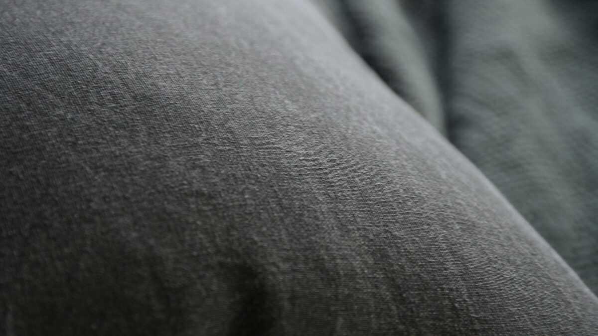 black cotton cushions with ivory coloured edges shown close up