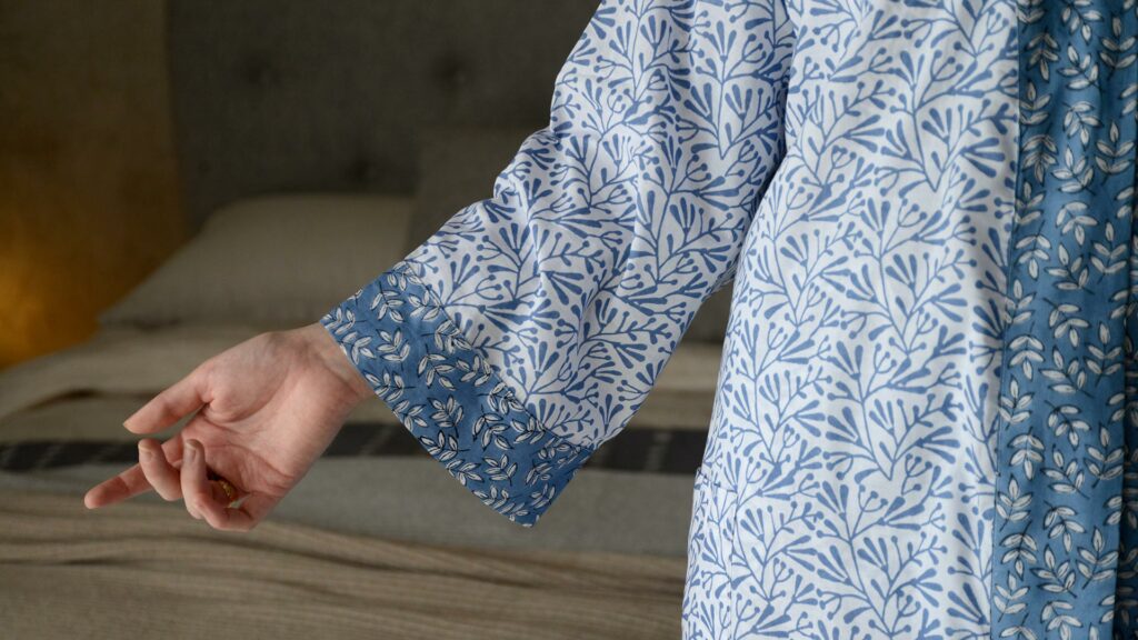 lightweight white cotton robe with a block print leaf design in blue and with contrast belt and cuffs