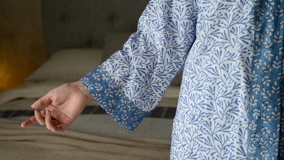 lightweight white cotton robe with a block print leaf design in blue and with contrast belt and cuffs