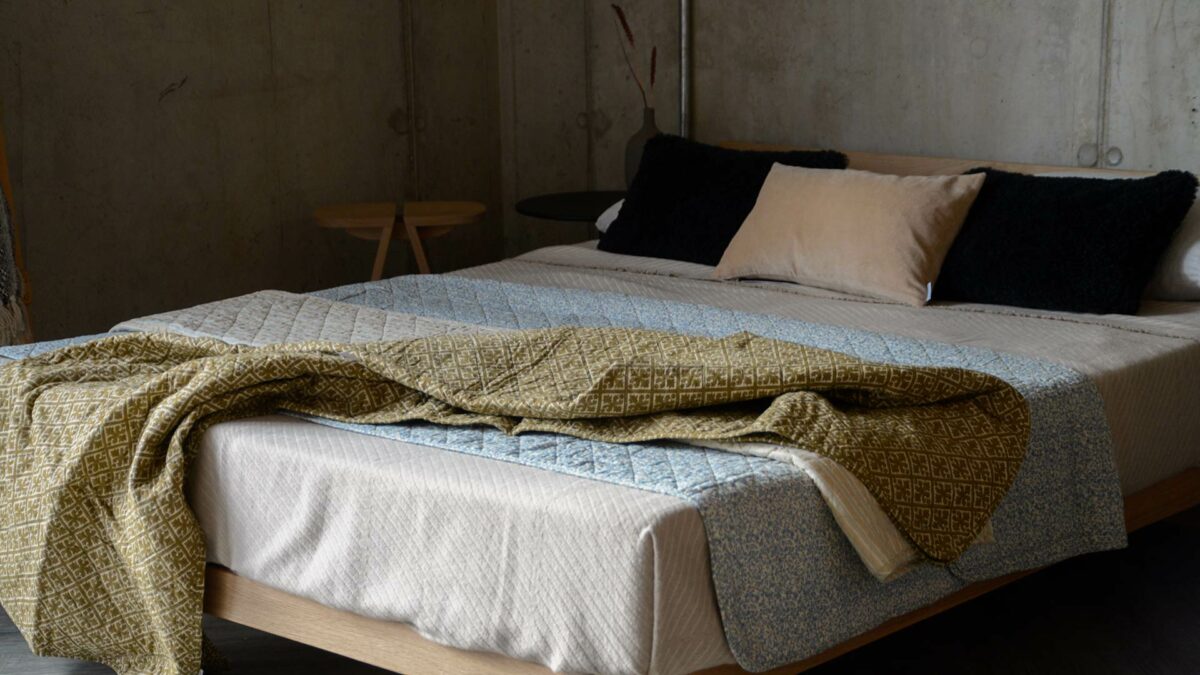 cream and blue patterned quilts