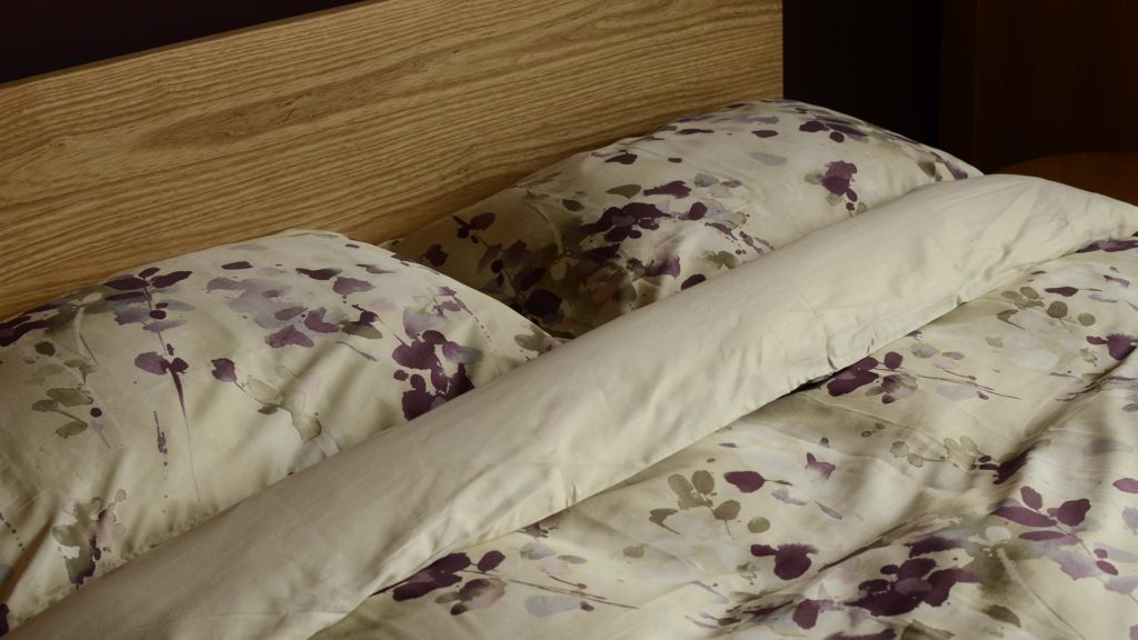 Printed duvet set in mauve and cream on our Ash Tibet wooden bed