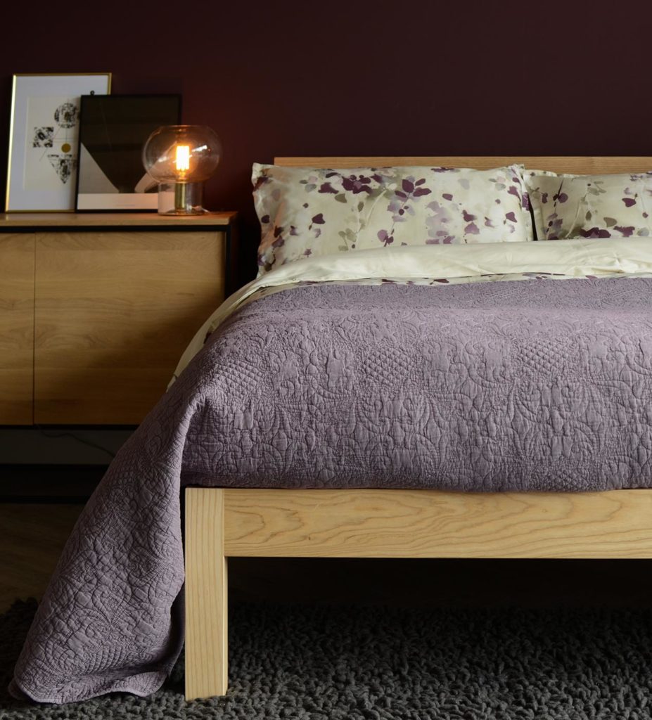 Contemporary solid wood Tibet bed with mauve printed bedding