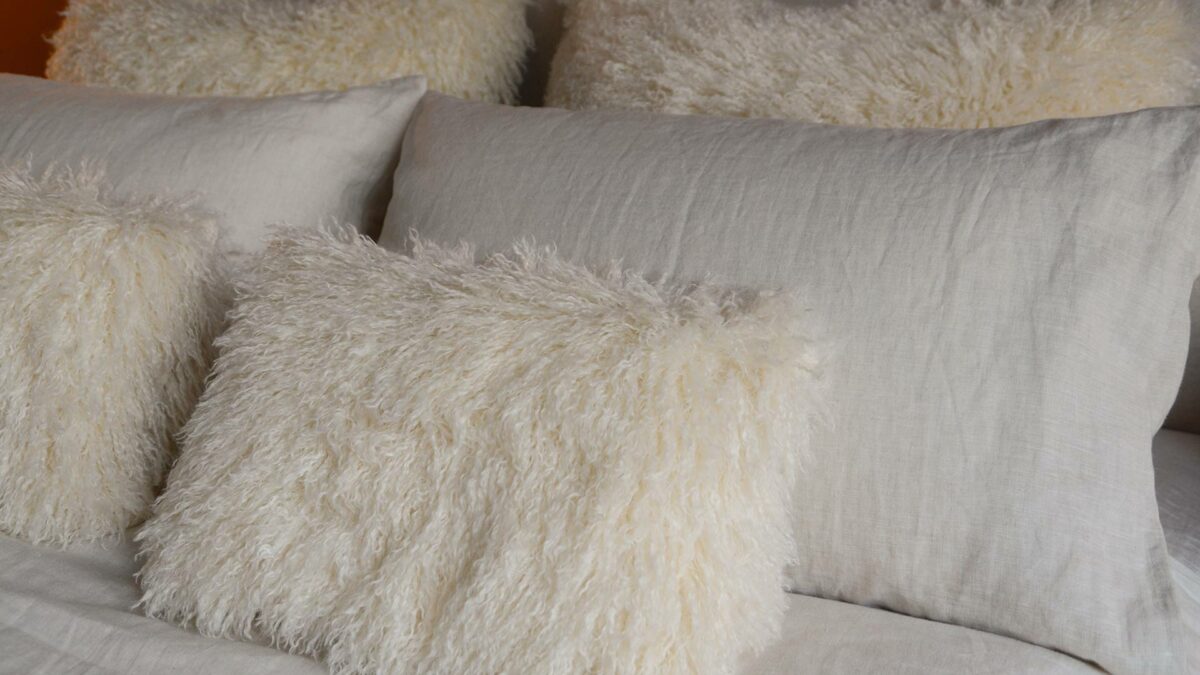cream faux aghan oblong cushions