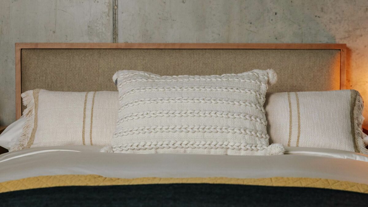 cream woven cushion with tassel detail