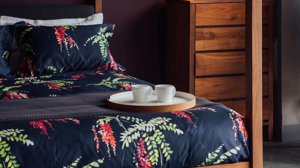 Printed floral duvet set on our hand crafted walnut Highland 4 poster bed