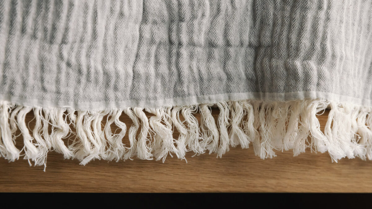 crinkle throw in grey fringe detail