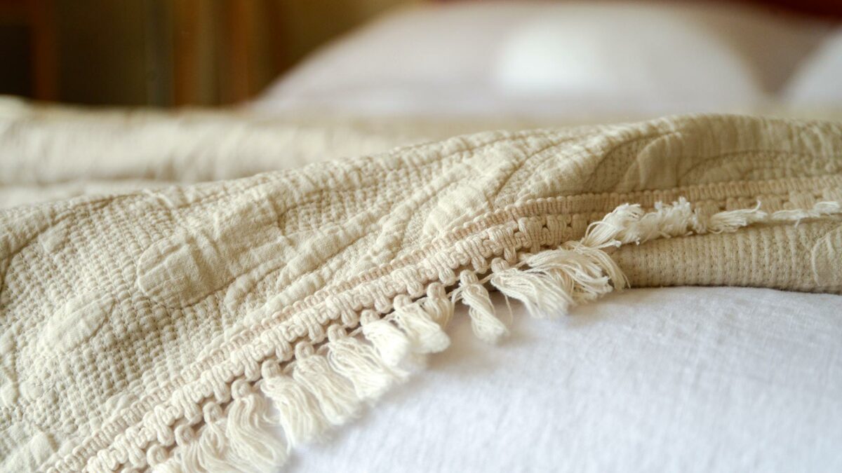 crream tasselled edge on embroidered throw