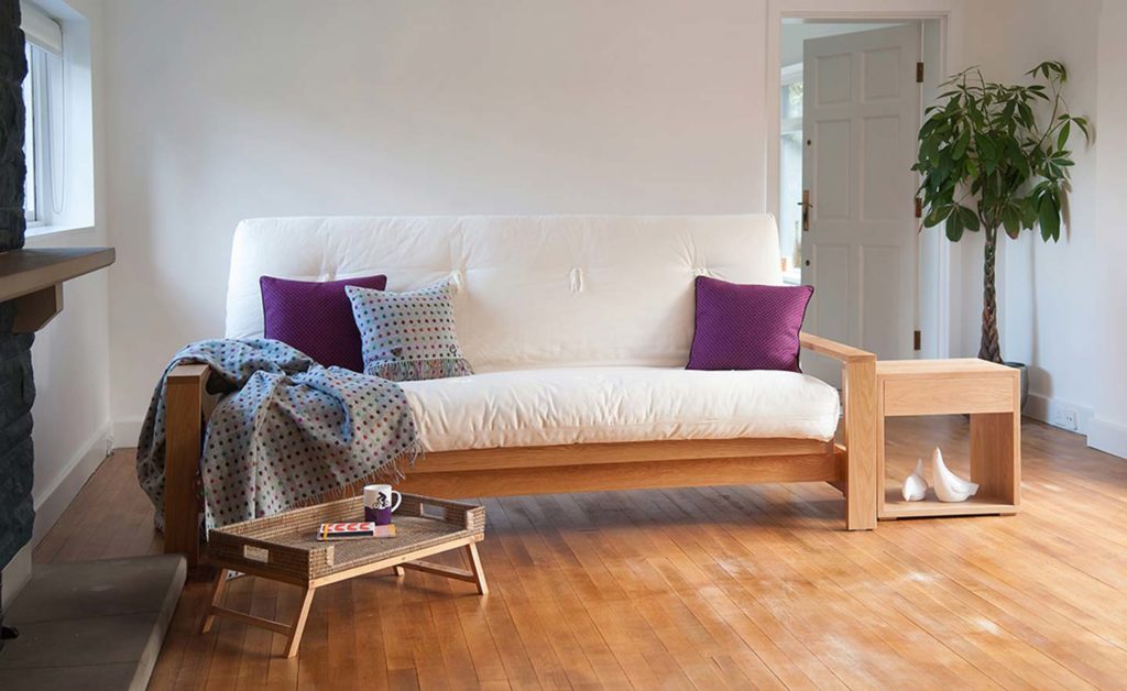 Cuba Futon Sofa Bed shown as a sofa and in Oak