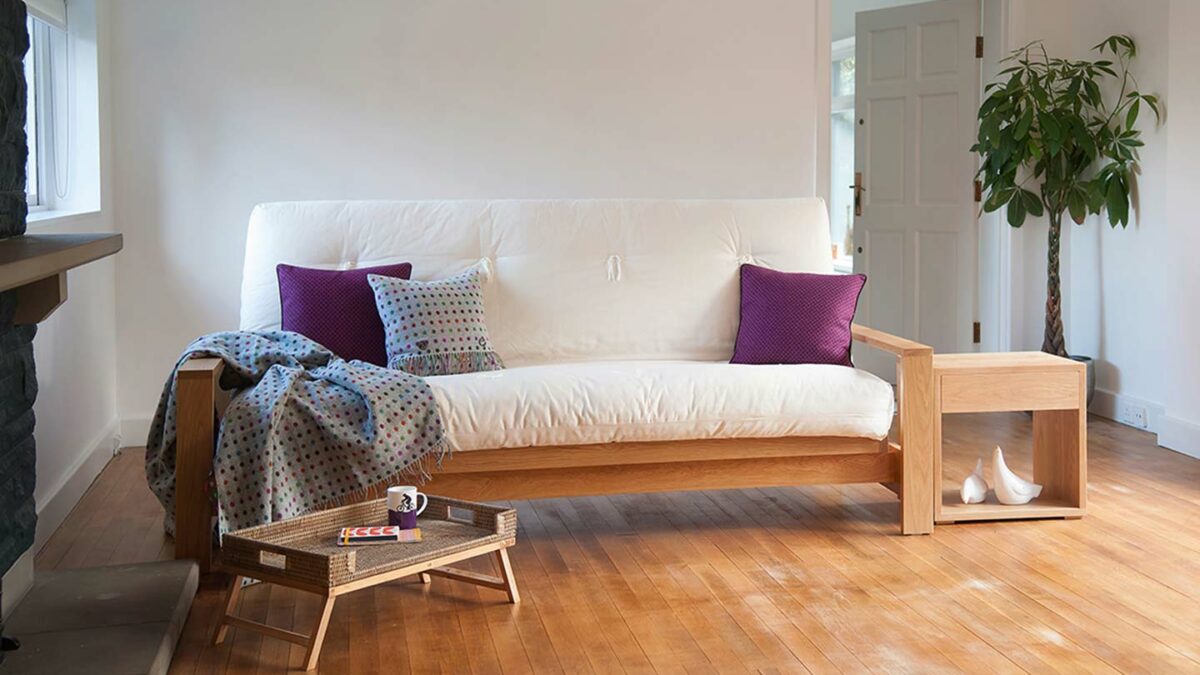 Cuba Futon Sofa Bed shown as a sofa and in Oak