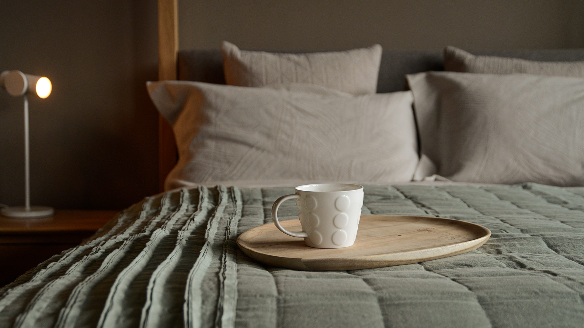 cup on highland with sage ruffle edge throw