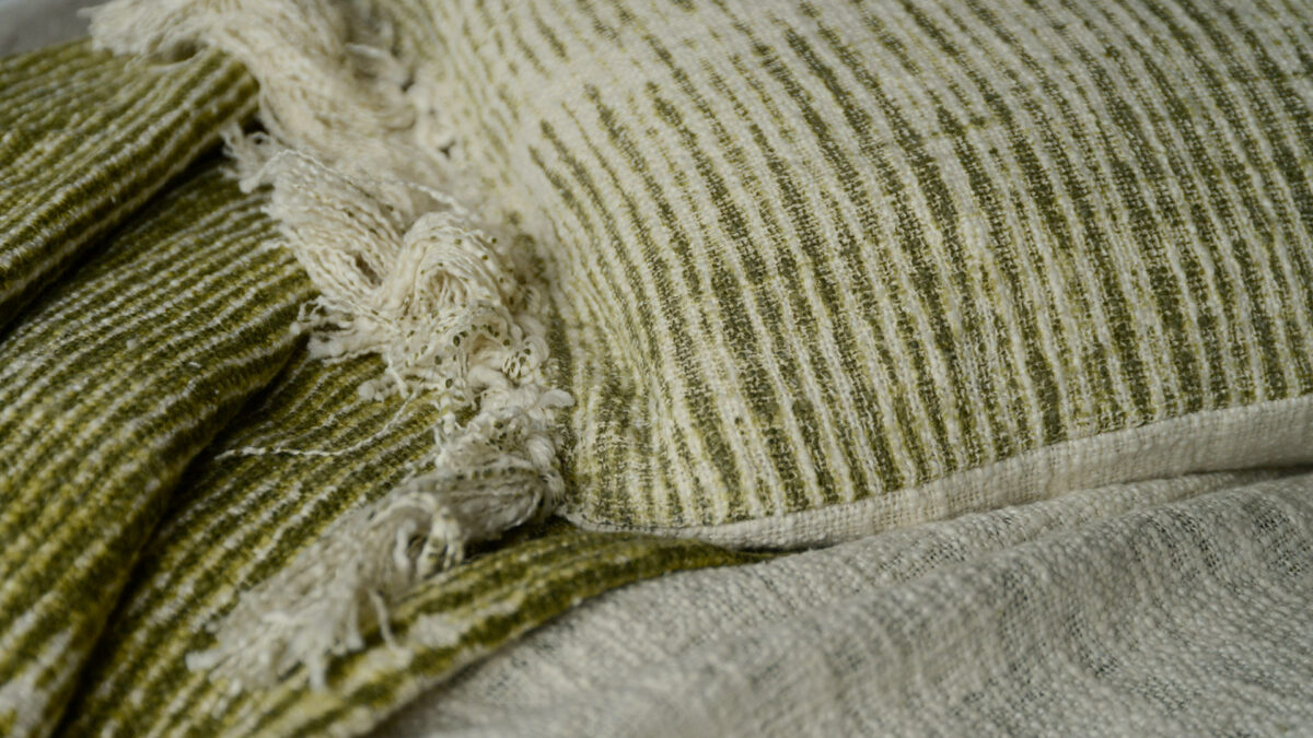 cushion and throw in ivory and olive green detail