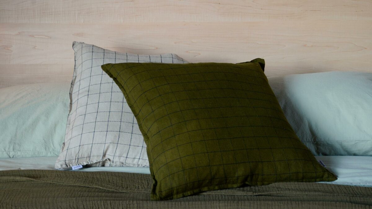 cushion with contemporary grid pattern stone or dark olive
