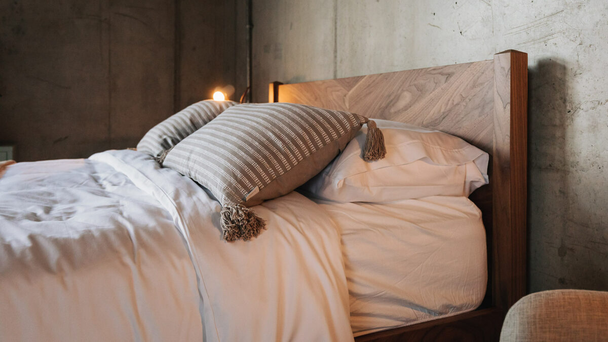 a closer view of the walnut Dalston bed chevron patterned headboard