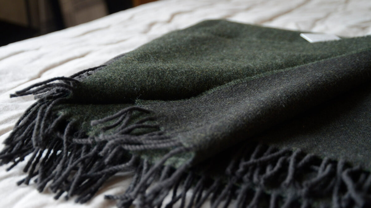 reversible pure wool throw in Fir Green and slate grey shown close up