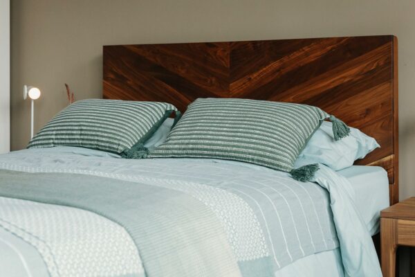 dark green and white tasseled cushions