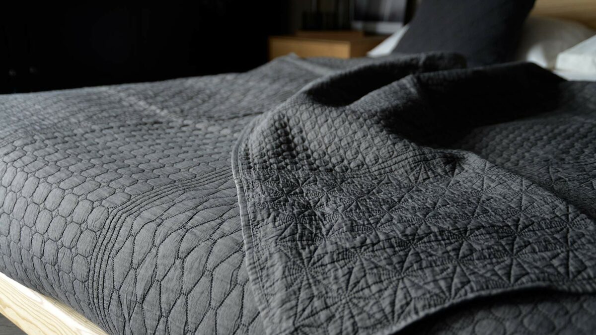 dark grey bedspreaad with embroidered pattern