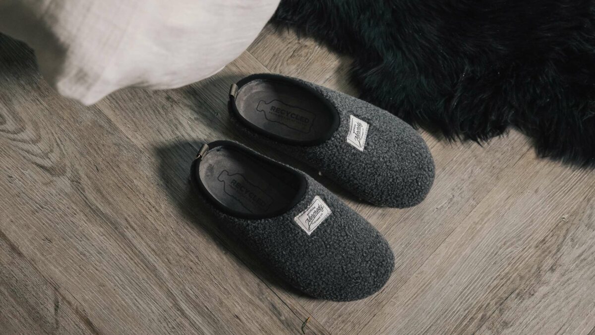 dark grey fleecy slippers made from recycled materials