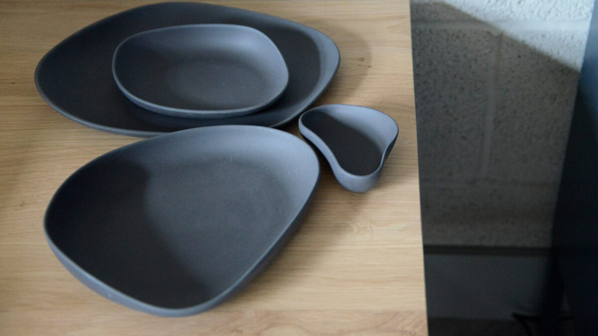 matt finish irregular shaped porcelain dishes set in dark grey