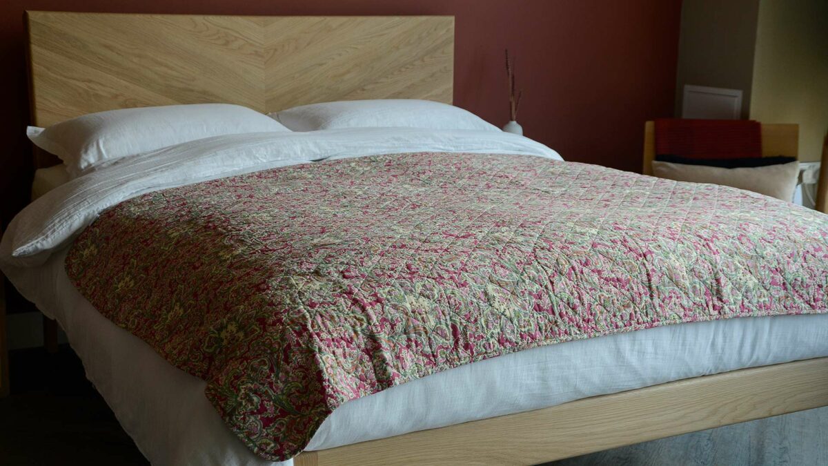 dark raspberry paisley quilted throw