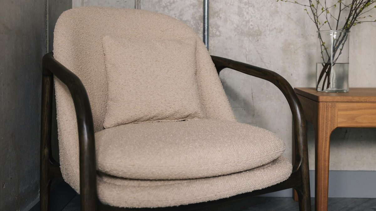 dark wood and beige boucle bedroom chair detail
