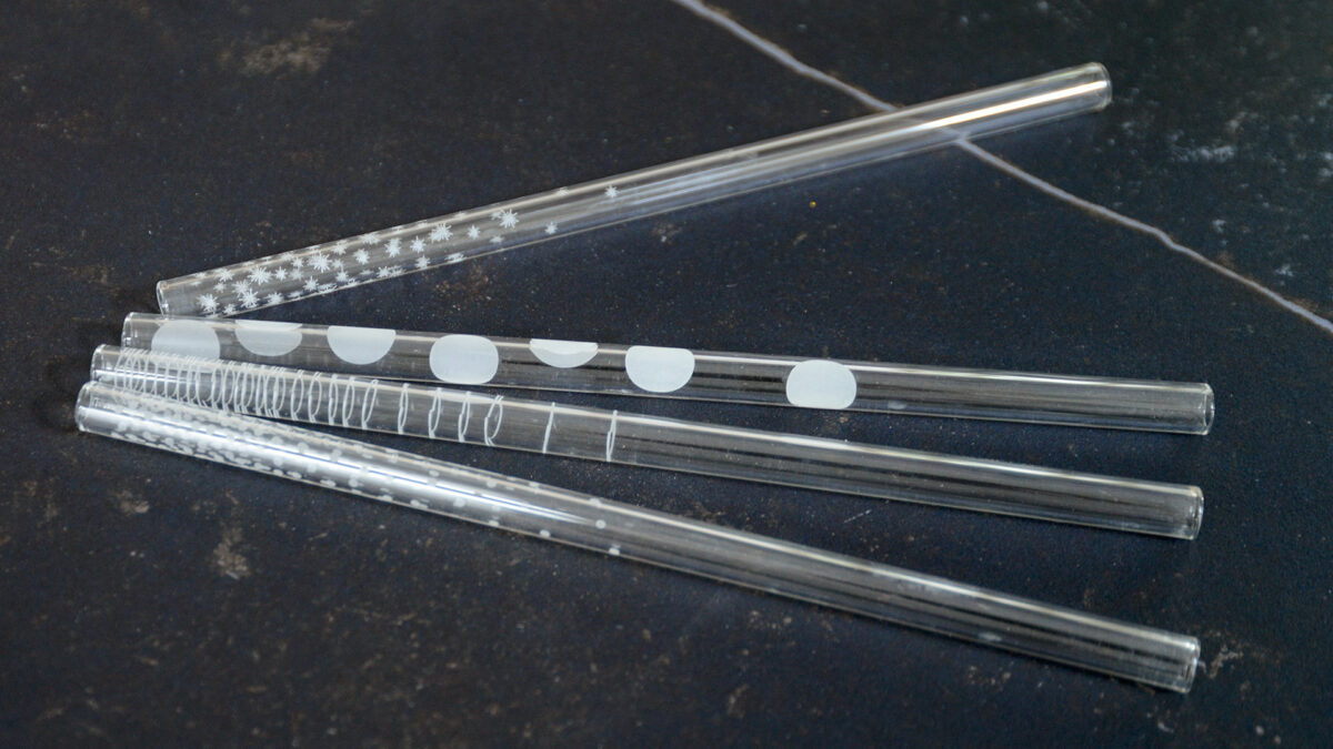 set of patterned glass drinking straws shown close up