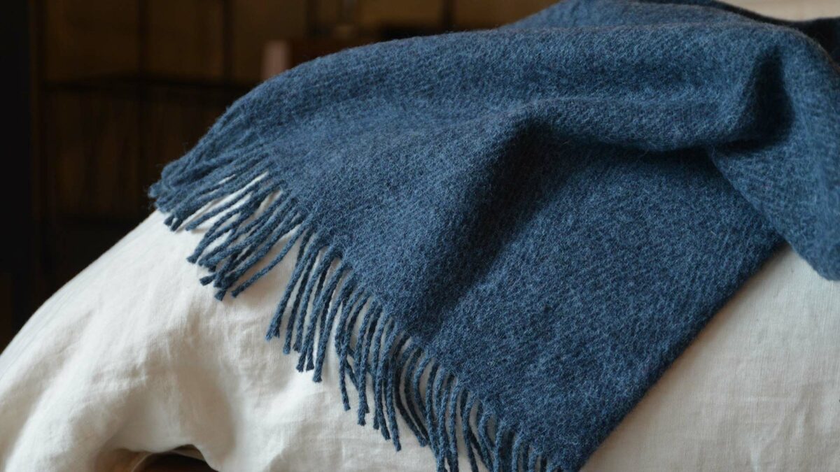 Denim blue herringbone weave pure wool throw with fringed edging