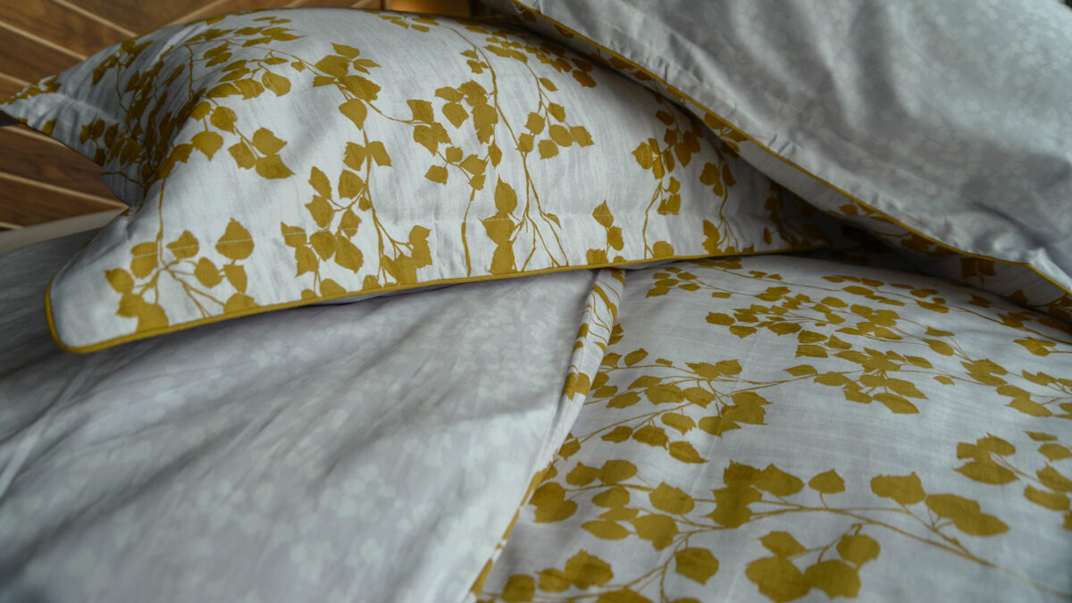 reversible leaf print duvet cover set in mustard yellow and white a close up view