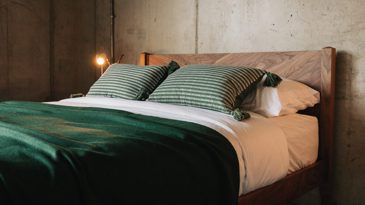 deep green throw and cushions on dalston bed