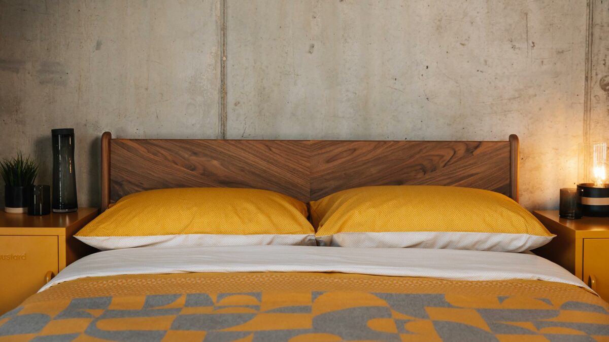 yolk yellow bedding against our chevron patterned walnut Hoxton headboard