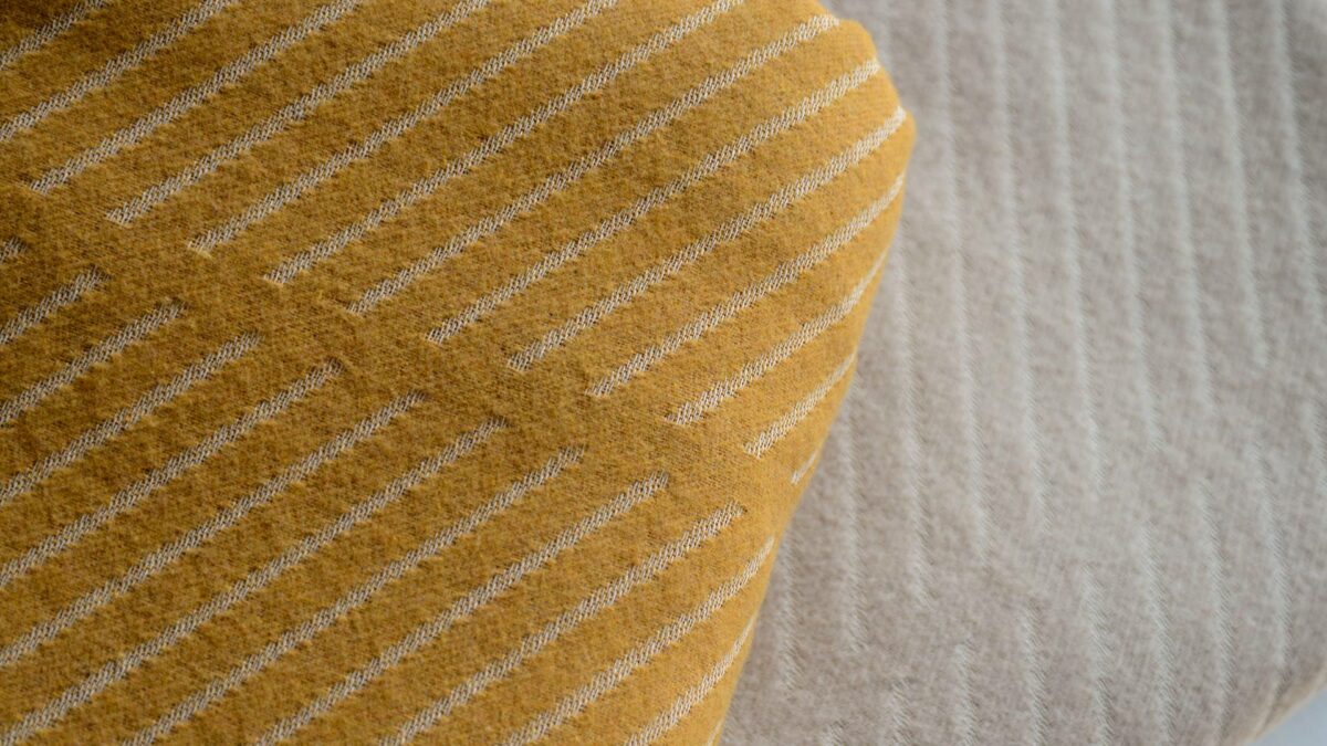 diagonal striped bedspreads in yellow ochre and grey