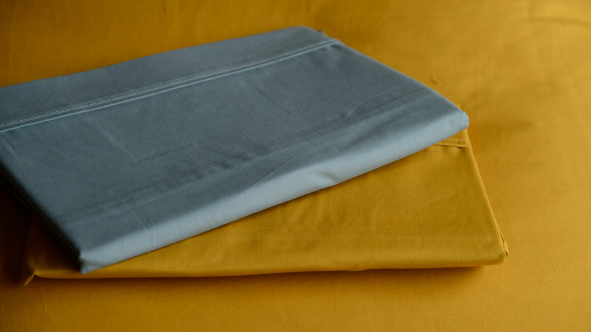 Egyptian cotton bedding available in ochre and storm blue shown together