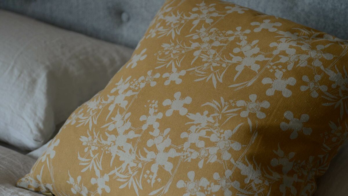 deep yellow and stone coloured floral print cushions