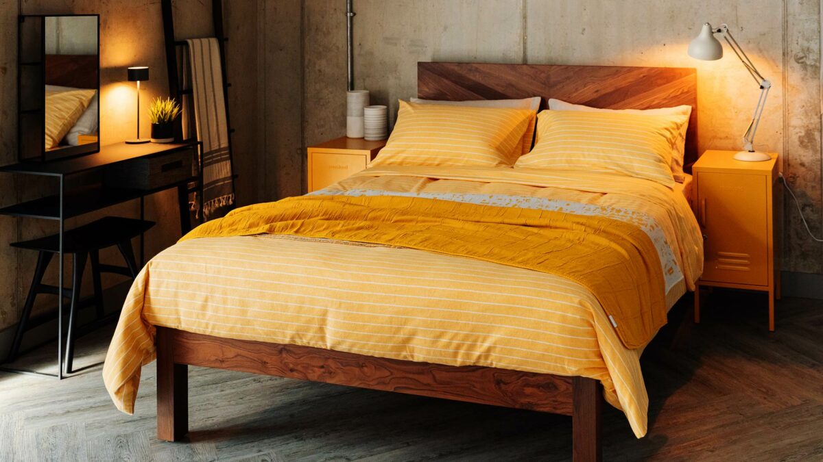 sunny yellow bedding shown on our solid walnut wood Hathersage wooden bed