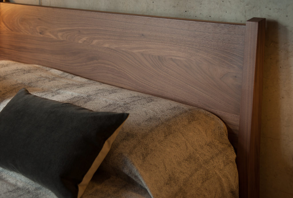 A closer view of the tall headboard of our walnut Zanskar bed.