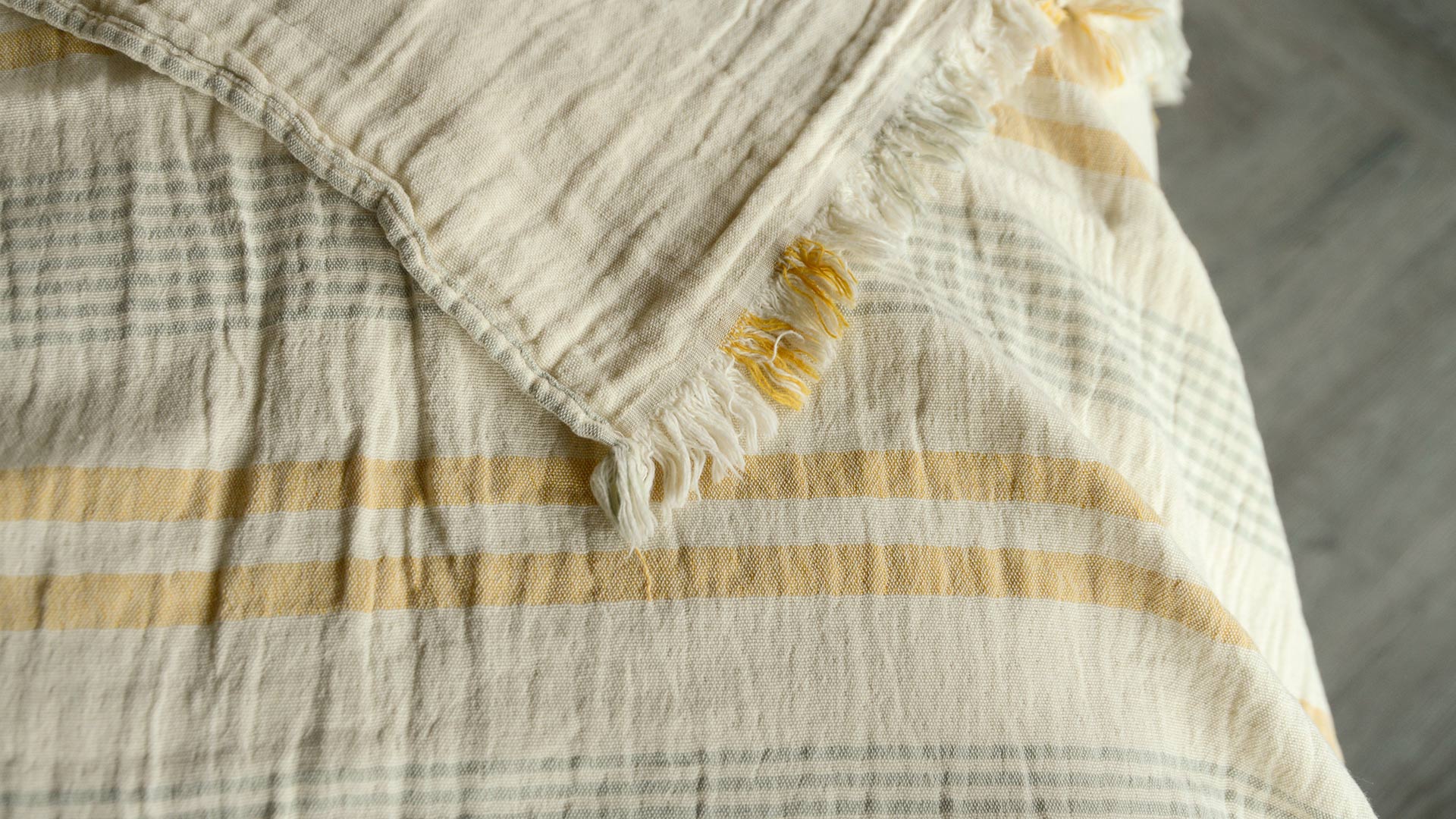 lightweight cotton throw in ivory with pale sage and yellow stripes