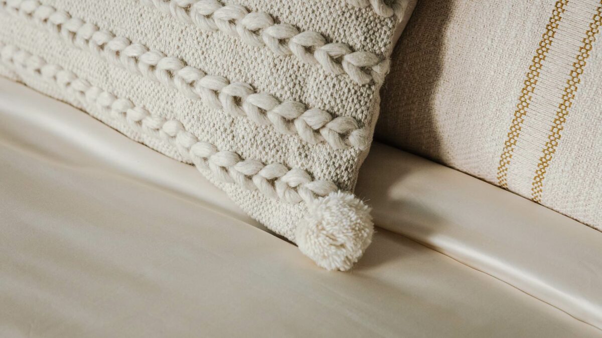 detail of organic sateen cotton bedding with woven cushion 1