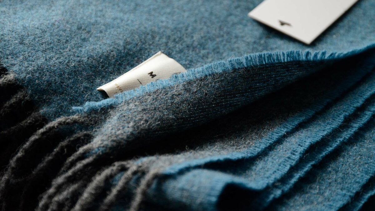 detail of reversible teal and charcoal throw