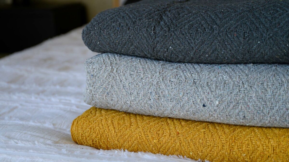 diamond weave cotton throws in 3 colour ways shown close up and stacked